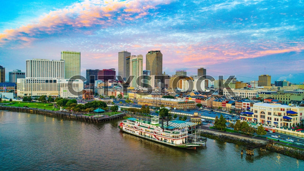 New Orleans skyline at sunrise with Mississippi River and riverboat