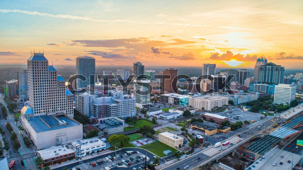 Aerial sunset view of Orlando cityscape with colorful skies