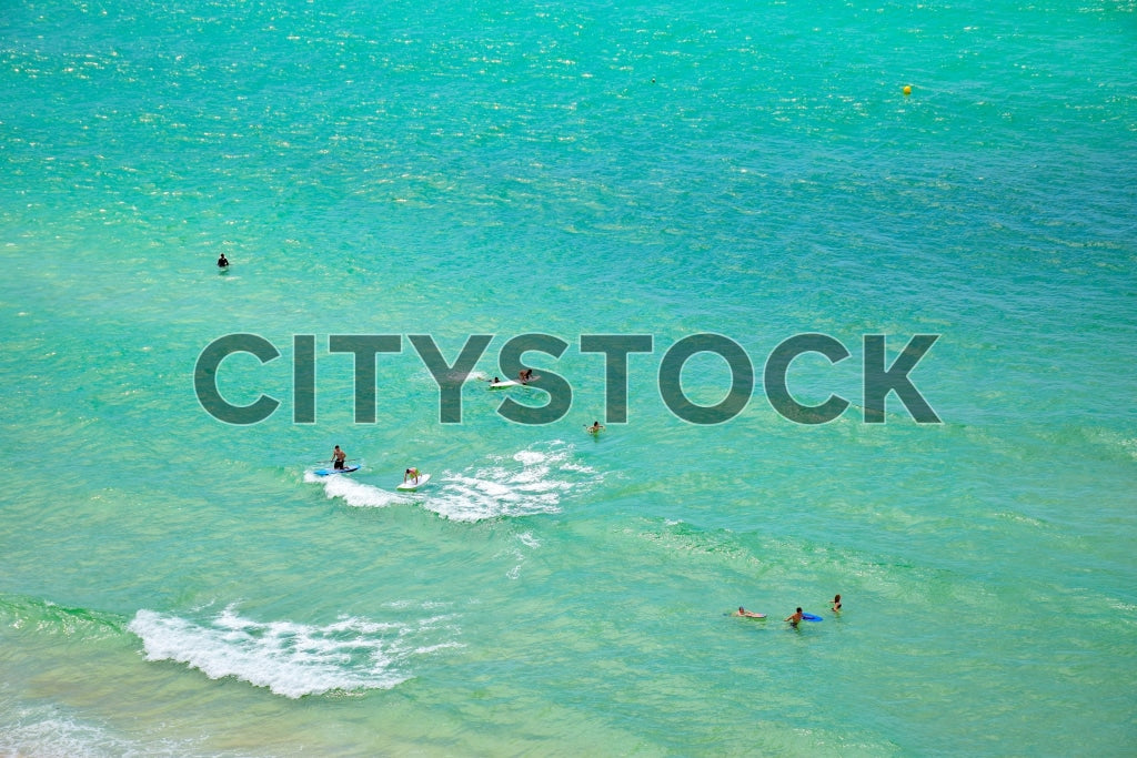 Aerial view of turquoise waters and beach goers at Panama City Beach