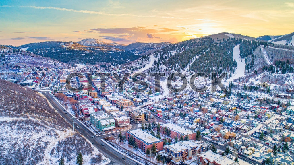 Aerial view of Park City, Utah during sunrise with snow-covered landscape
