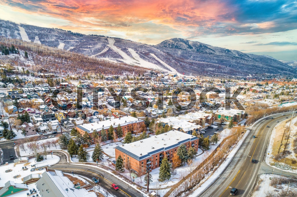 Aerial view of snowy Park City, Utah at sunrise with colorful skies
