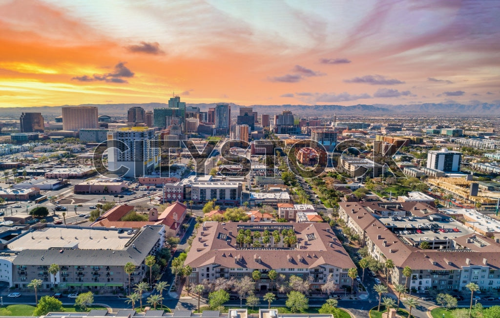 Aerial view of Phoenix downtown skyline and mountains at sunset