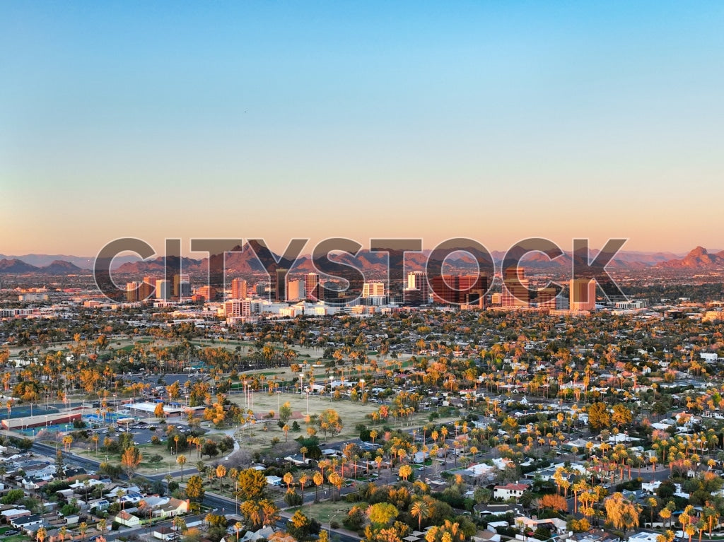 Aerial view of Phoenix skyline at sunset with mountains in the background