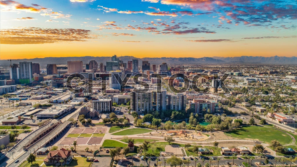 Aerial view of Phoenix, AZ skyline at sunset with mountains