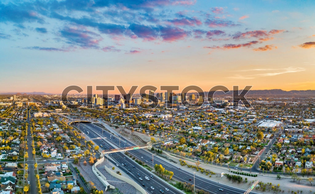 Aerial view of Phoenix, AZ cityscape during sunset with vibrant skies
