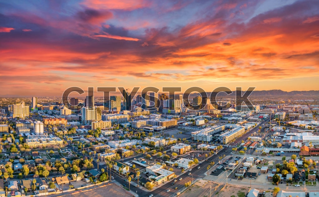 Aerial view of Phoenix cityscape with vibrant sunset and city lights
