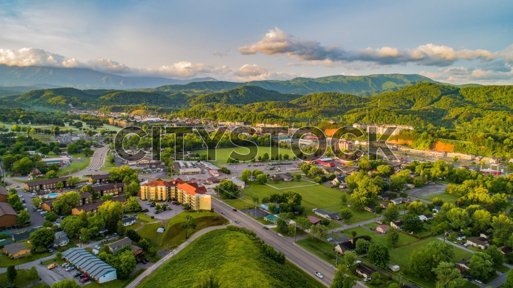 Aerial view of Pigeon Forge, Tennessee at sunset displaying the city and mountains