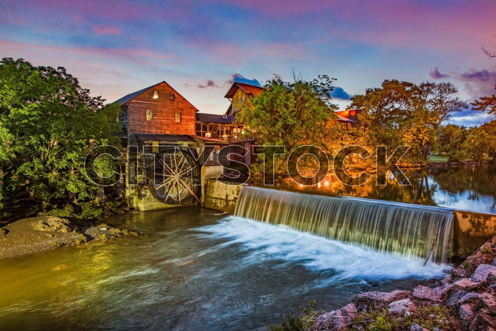 Historic old mill by a waterfall at sunset in Pigeon Forge, TN