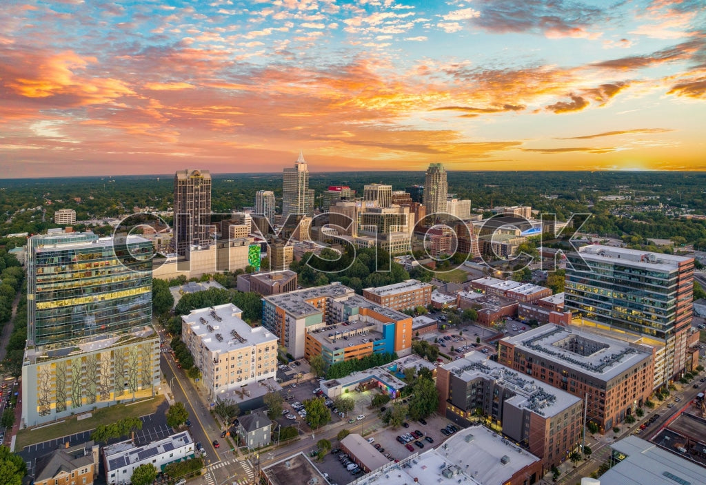 Aerial evening view of Raleigh skyline with sunset hues casting over buildings.