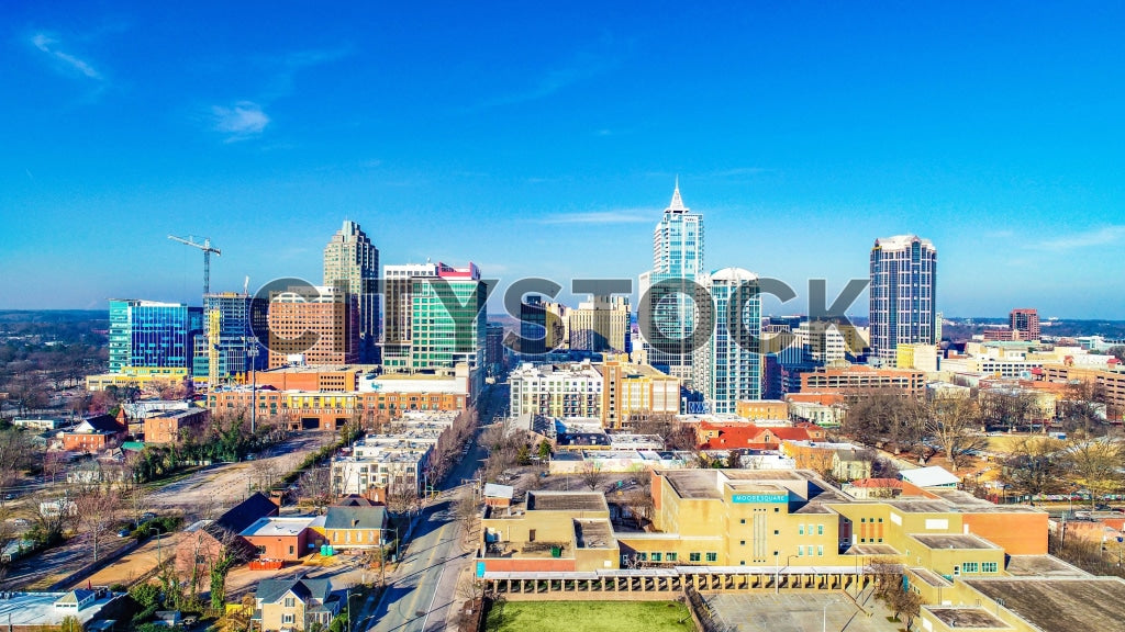 Aerial view of Raleigh skyline with modern buildings and blue sky