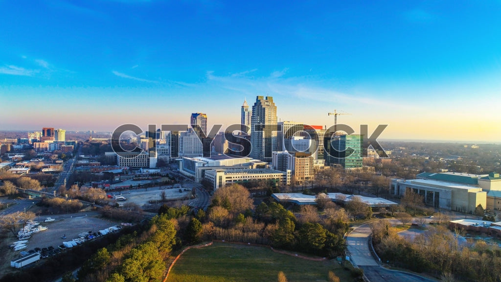 Aerial view of Raleigh NC skyline during golden hour with blue sky