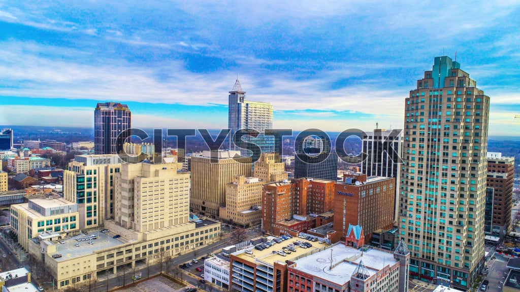 Aerial view of Raleigh, NC showing city buildings under blue sky