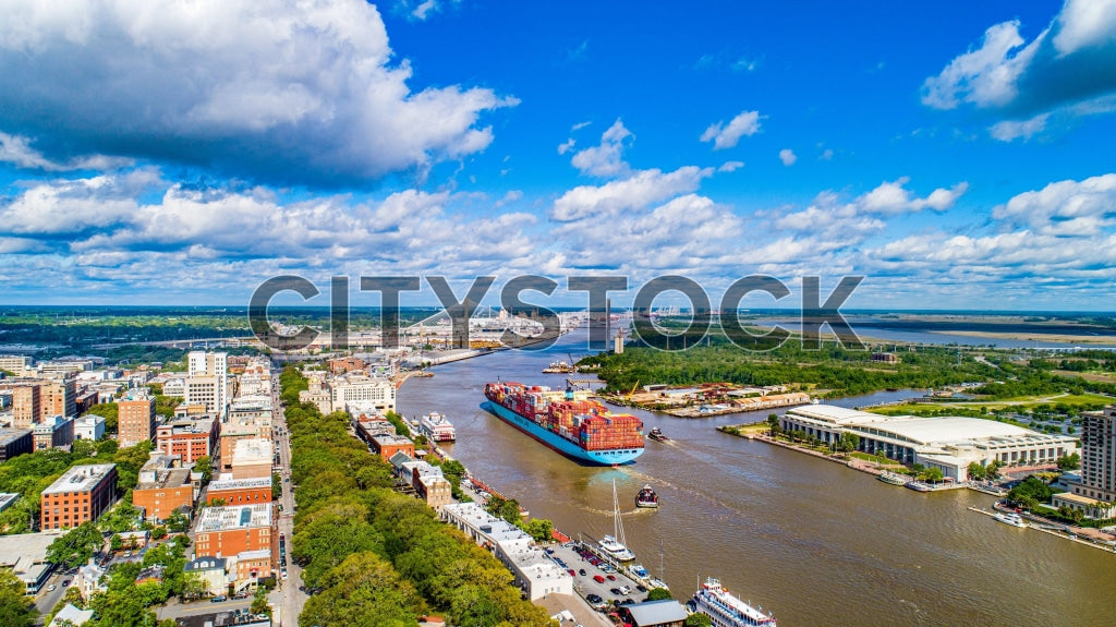 Aerial photo of cargo ship on Savannah River, historic Savannah cityscape