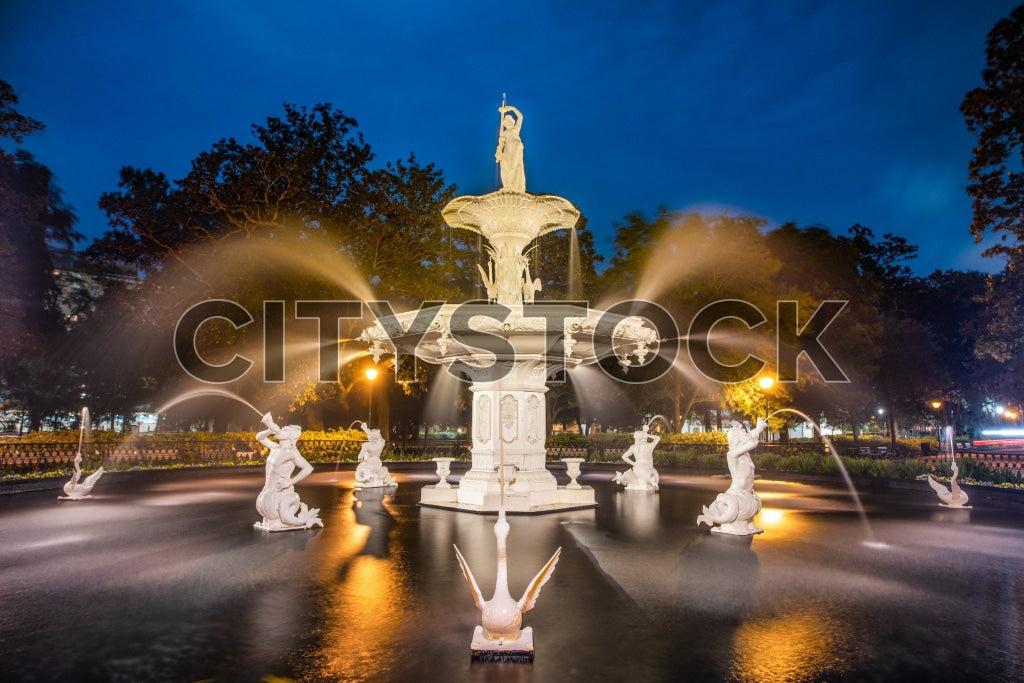 Illuminated historic fountain at night in Savannah, GA