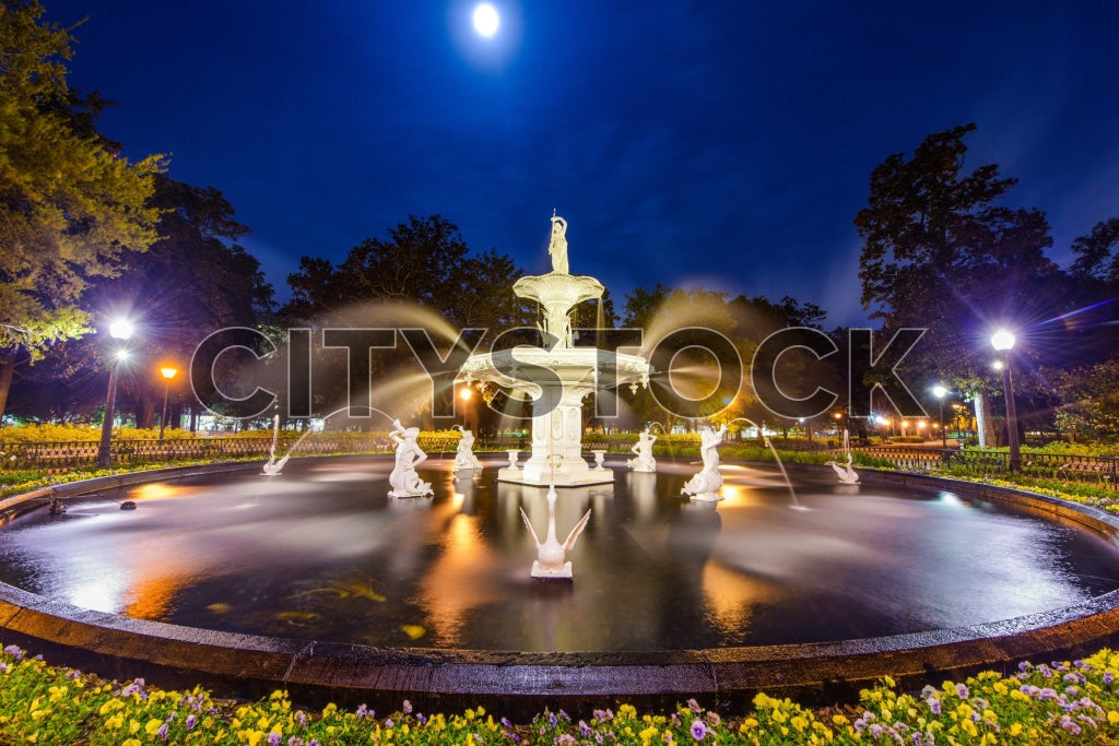 Grand fountain under moonlight with statues and flowers in Savannah