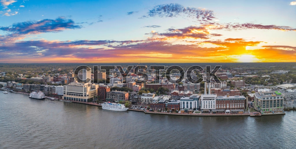 Aerial view of Savannah, GA riverfront at sunrise with colorful sky