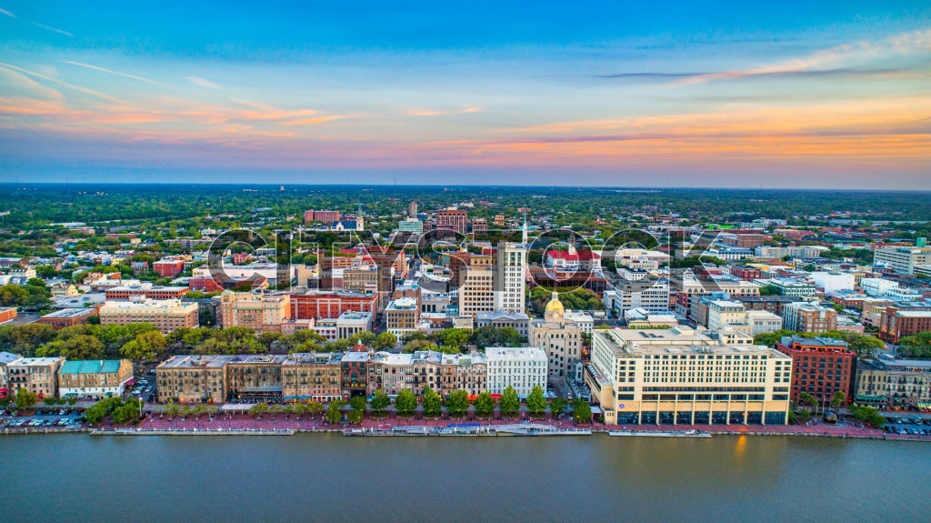 Aerial sunset view of Savannah, Georgia highlighting historic sites and river