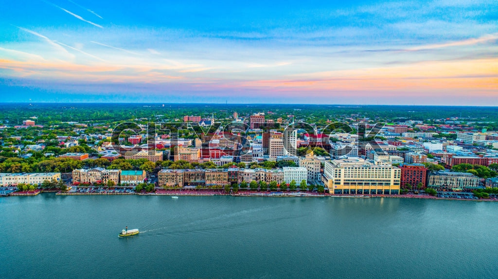 Aerial view of Savannah Riverfront at sunset with vibrant cityscape