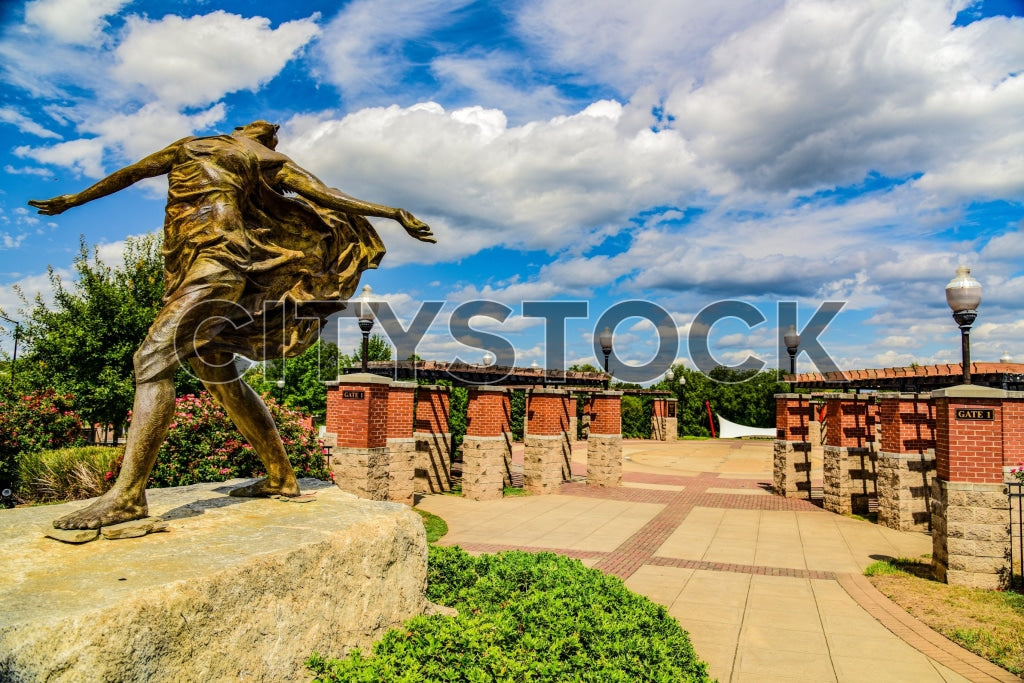 Dynamic bronze statue under blue sky in Spartanburg city park