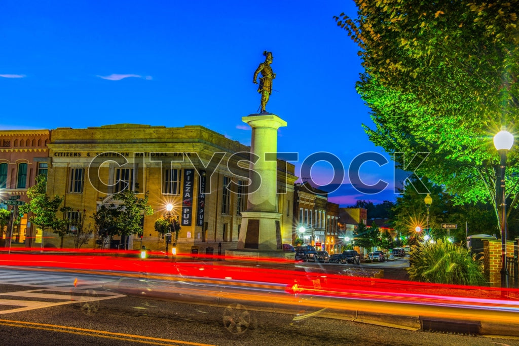 Night view of Spartanburg with light trails and historic buildings