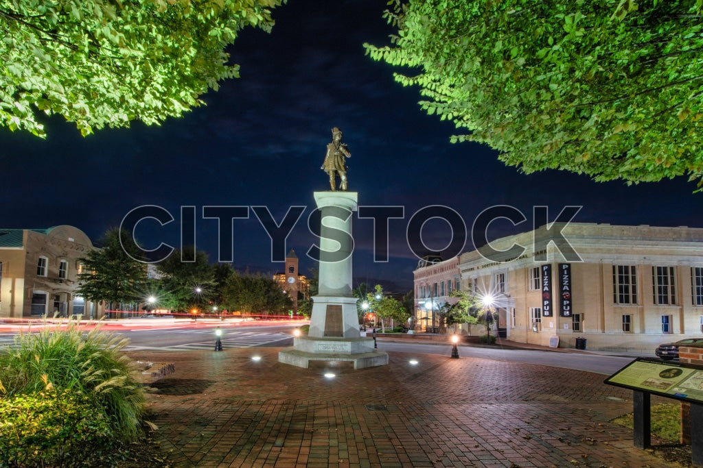 Spartanburg downtown area at night featuring historic statue