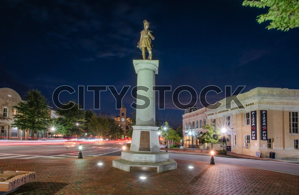 Historic monument in Spartanburg at night with urban lights and traffic