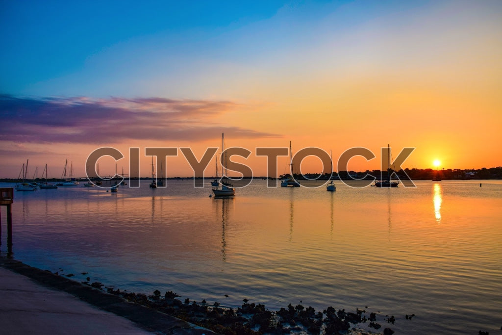 Sunrise with sailboats on tranquil waters in St Augustine, Florida