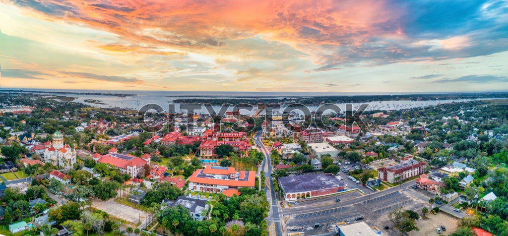 Aerial view of St. Augustine, FL at sunset showing historical and modern buildings