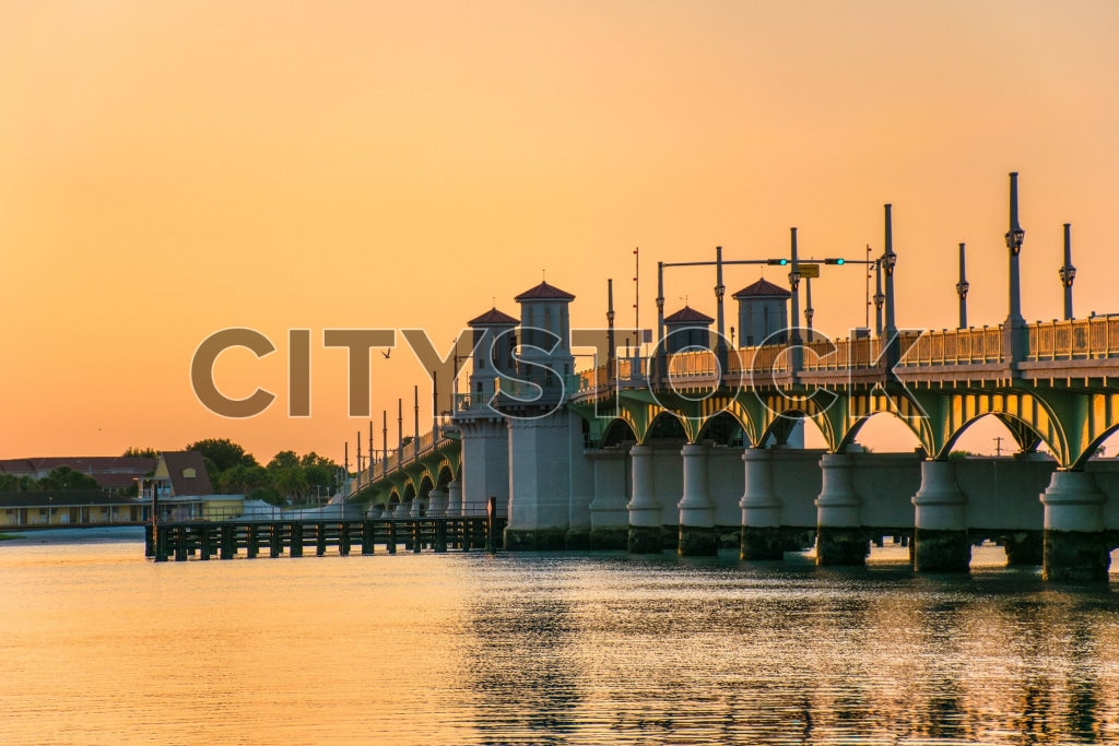 Sunset view of St. Augustine historic bridge with golden sky