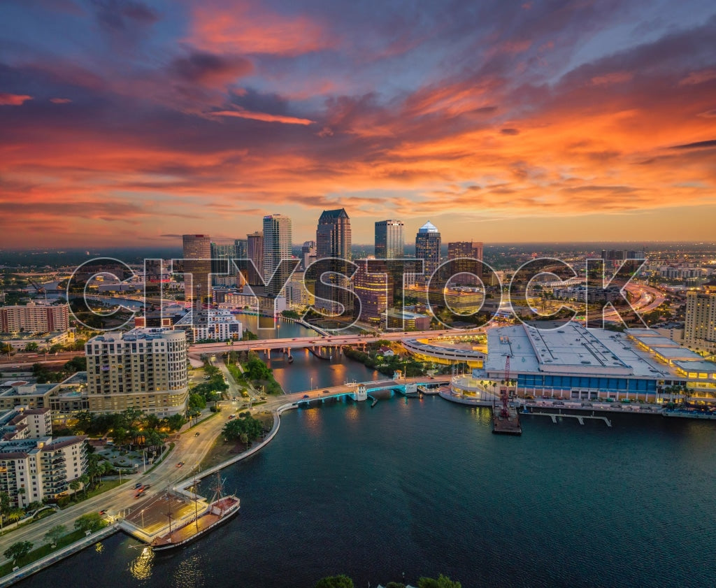 Aerial view of Tampa Bay during sunrise, highlighting urban cityscape.