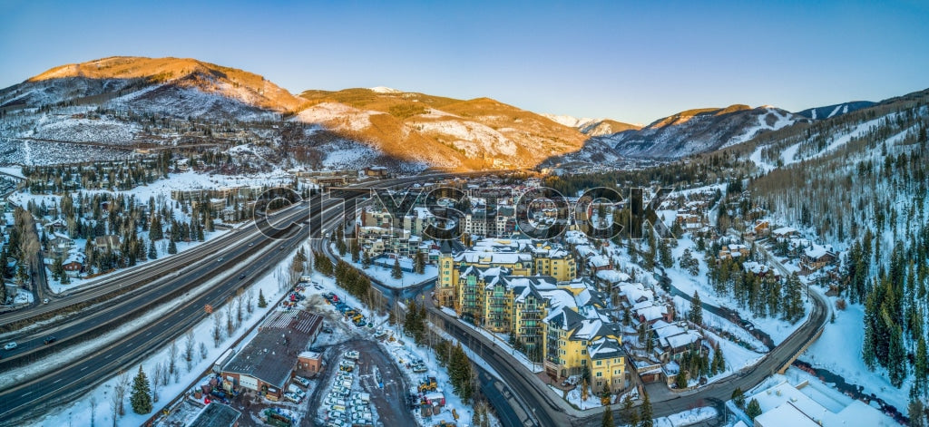 Aerial view of snowy Vail, Colorado at sunrise, highlighting winter landscape