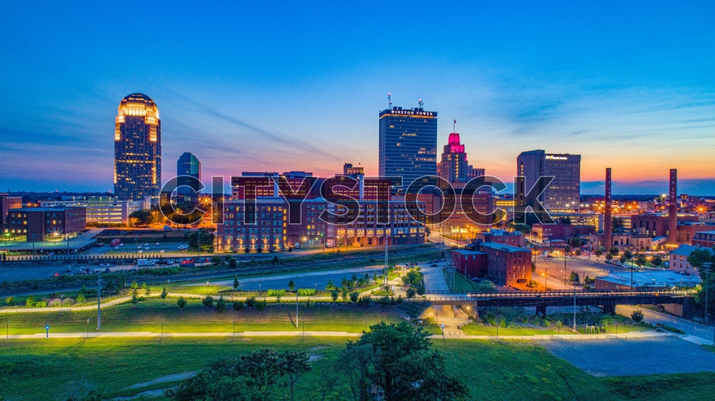 Aerial view of Winston-Salem at dusk showcasing city lights and buildings