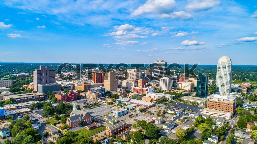 Aerial view of Winston-Salem cityscape under a clear blue sky
